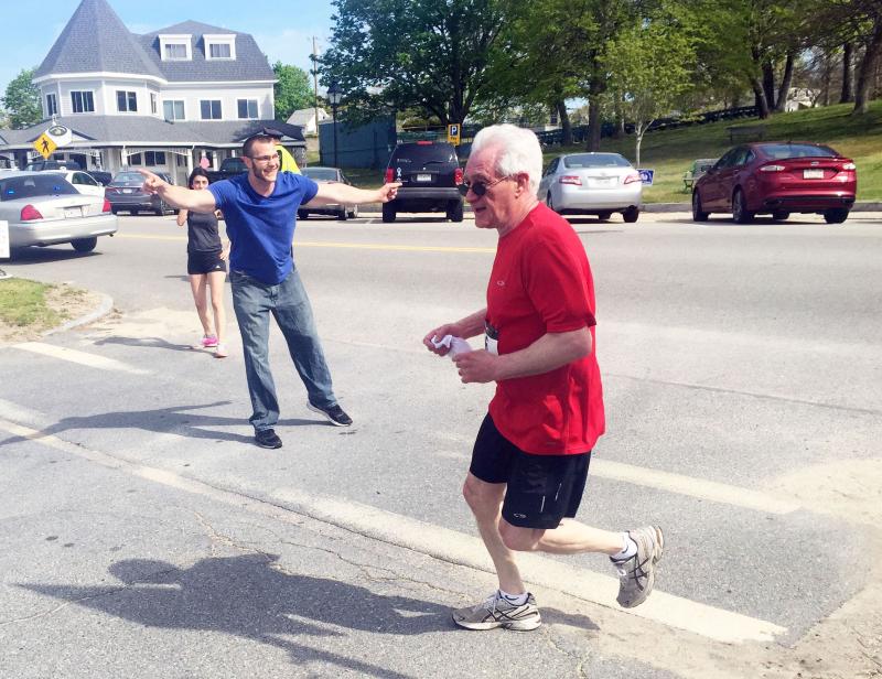 YMCA Southcoast Wellness Director Chris Koziol encourages Onset's Bill Lockwood during Saturday's 5K. BY MATTHEW BERNAT